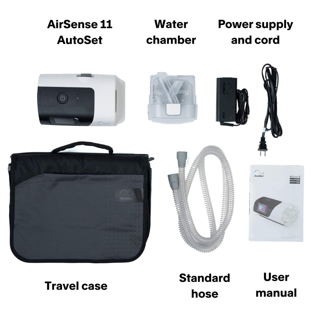 Complete ResMed AirSense 11 AutoSet CPAP machine kit, including the main device, humidifier chamber, power supply, power cord, CPAP hose, carrying case, and user manual, laid out on a white background.