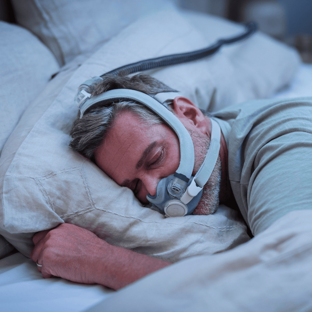 man sleeping soundly wearing the airtouch f30i comfort full face CPAP mask