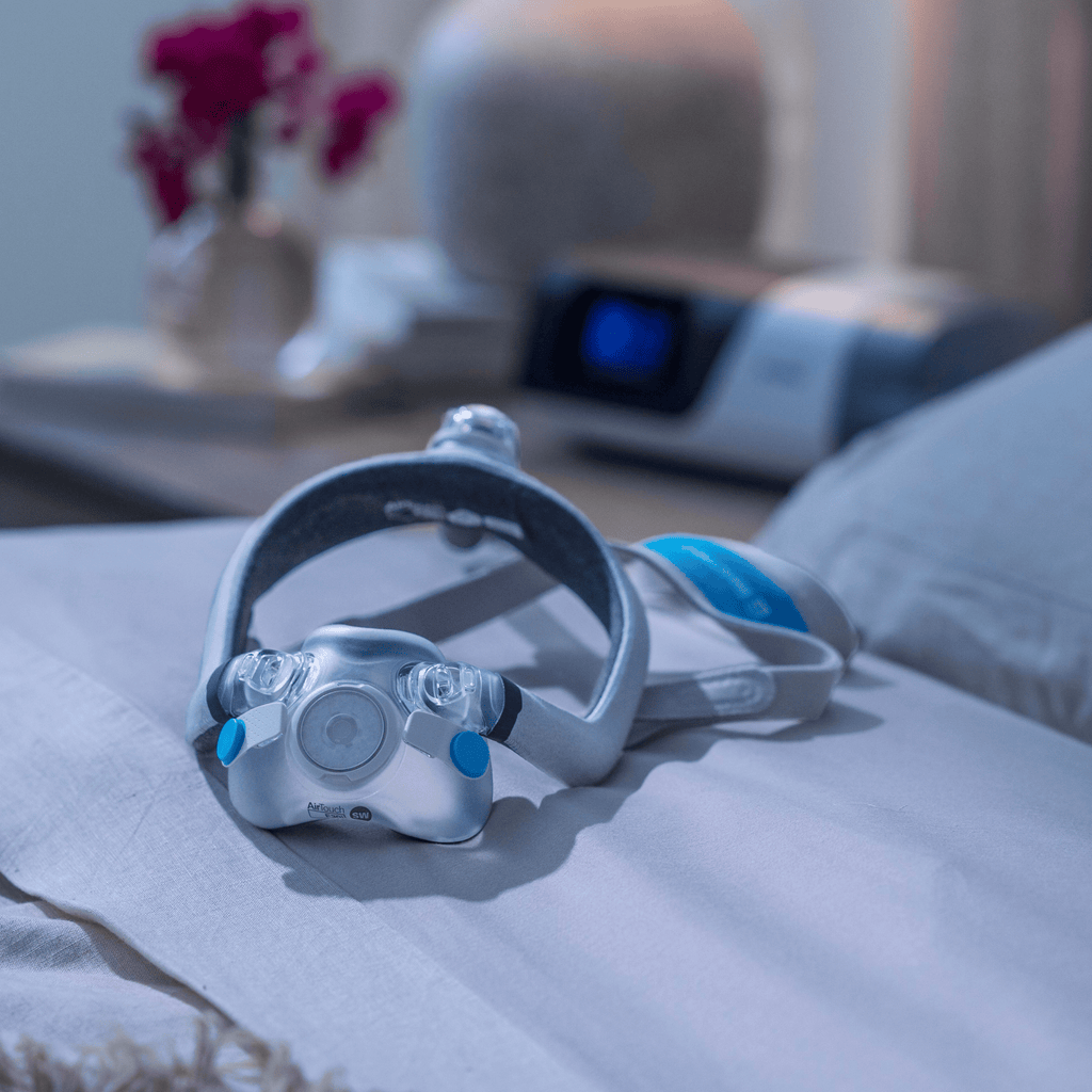 AirTouch F30i Comfort rests on bed with AirSense 11 in background