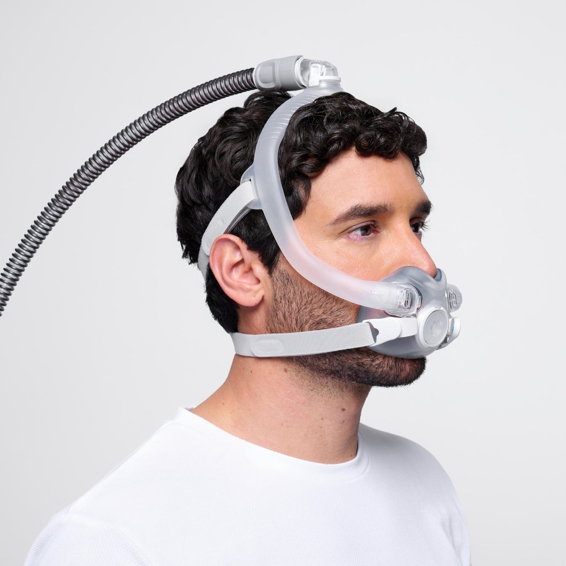 man seen from the left side wearing airtouch f30i full face cpap mask