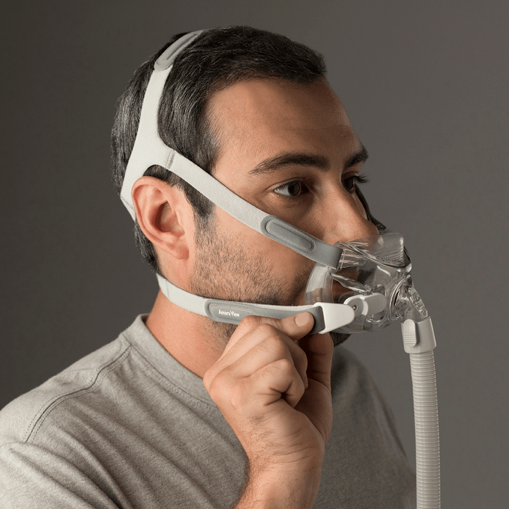 man connects magnetic headgear clip while wearing amara view