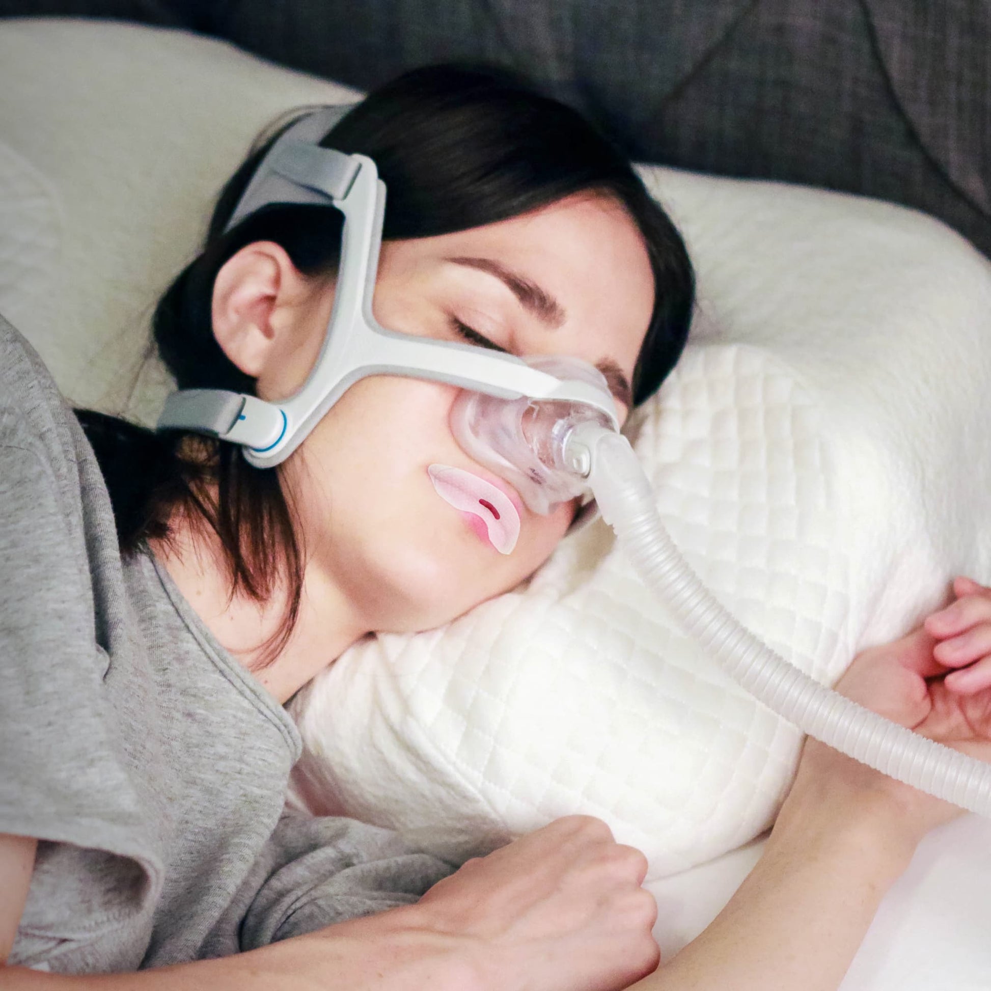 woman sleeping with CPAP Tape