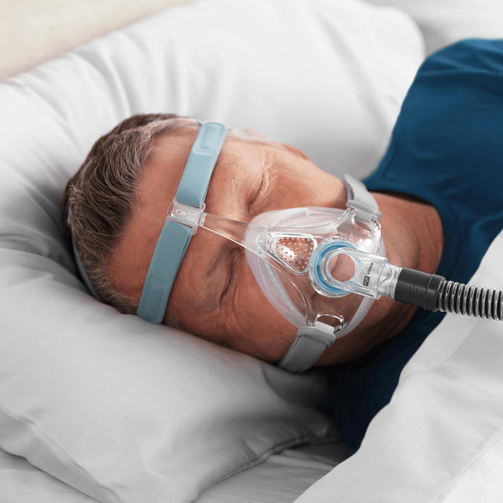 man sleeps soundly wearing fisher and paykel vitera full face cpap mask