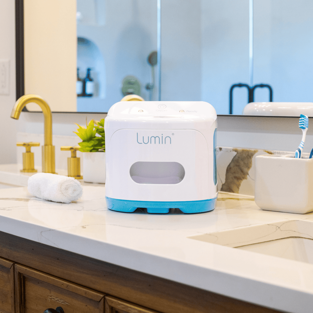 lumin sanitizer sitting on a clean, well-lit bathroom counter.