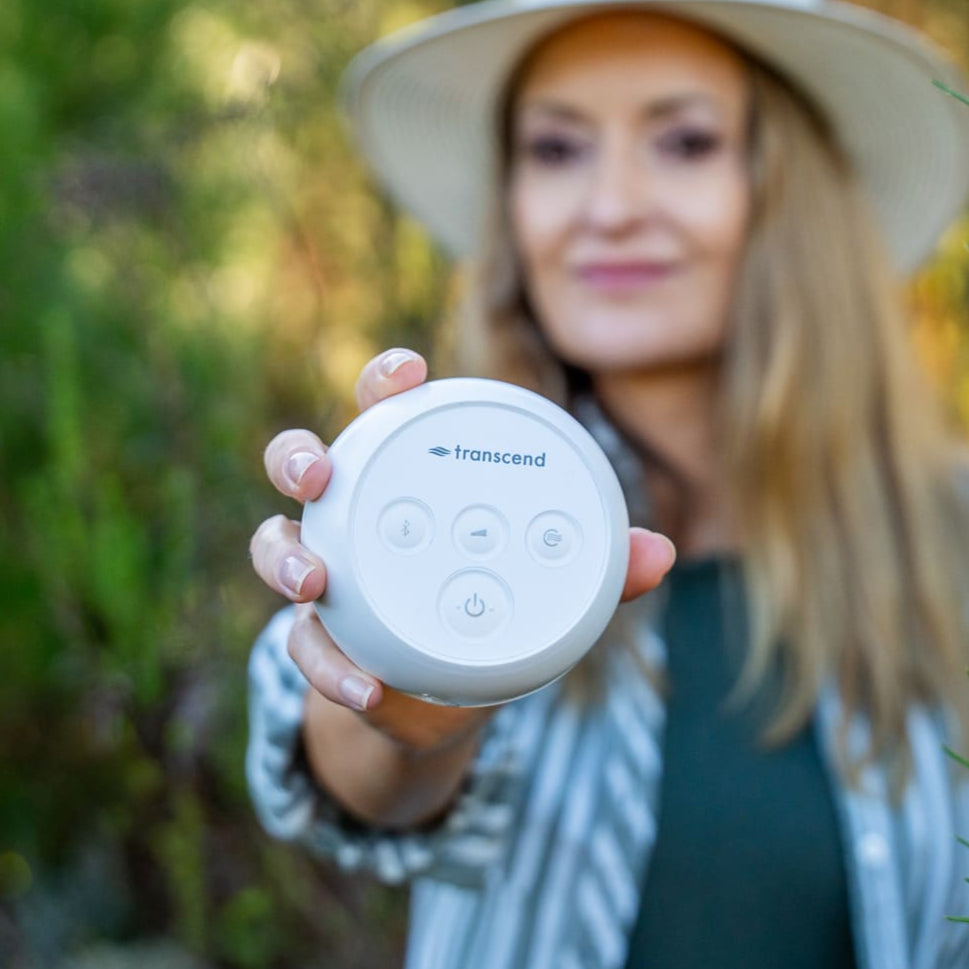 woman showing off the transcend micro to camera, highlighting its compact size.